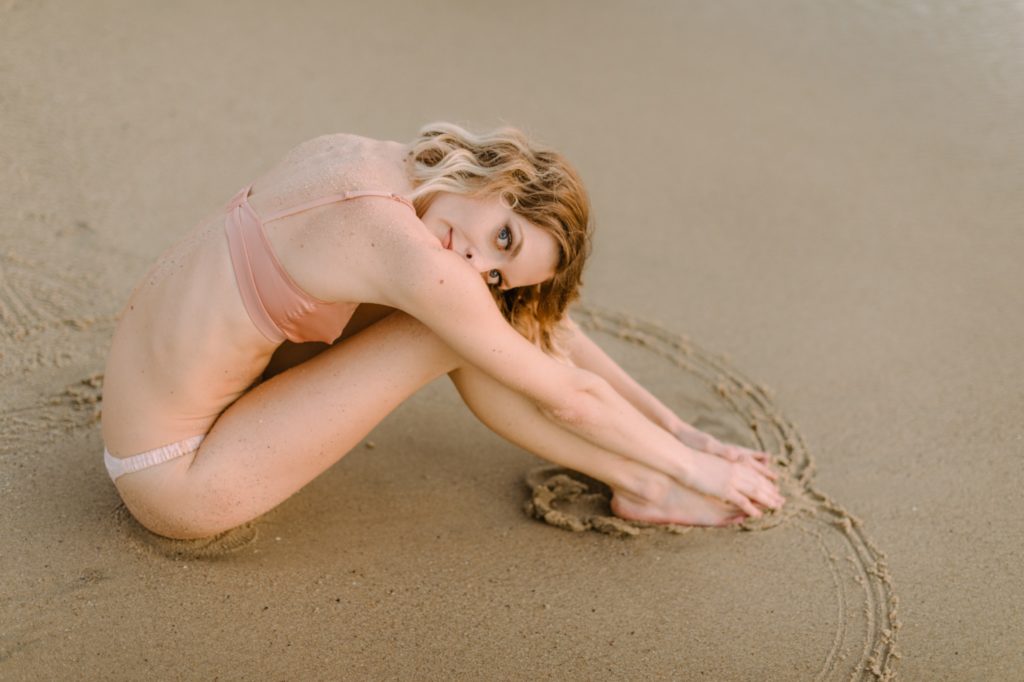 girl posing on wet sand for laguna beach boudoir session