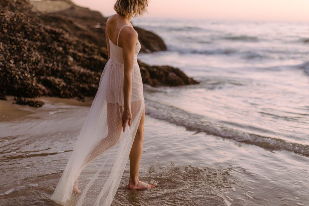 a girl walking on the beach for laguna beach boudoir session